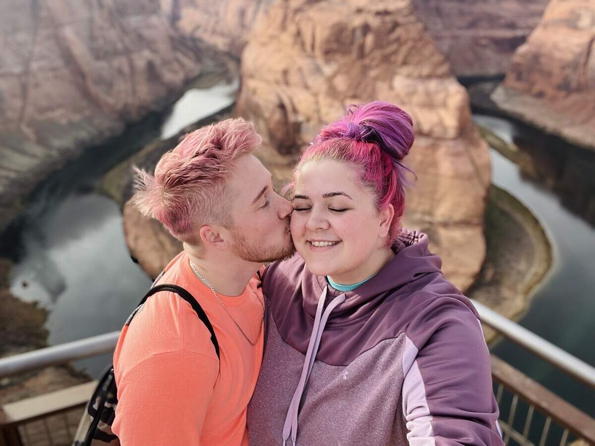 Samuel Ranz kisses Melissa Ranz on the cheek on their honeymoon road trip in Horsehoe Bend, Arizona.