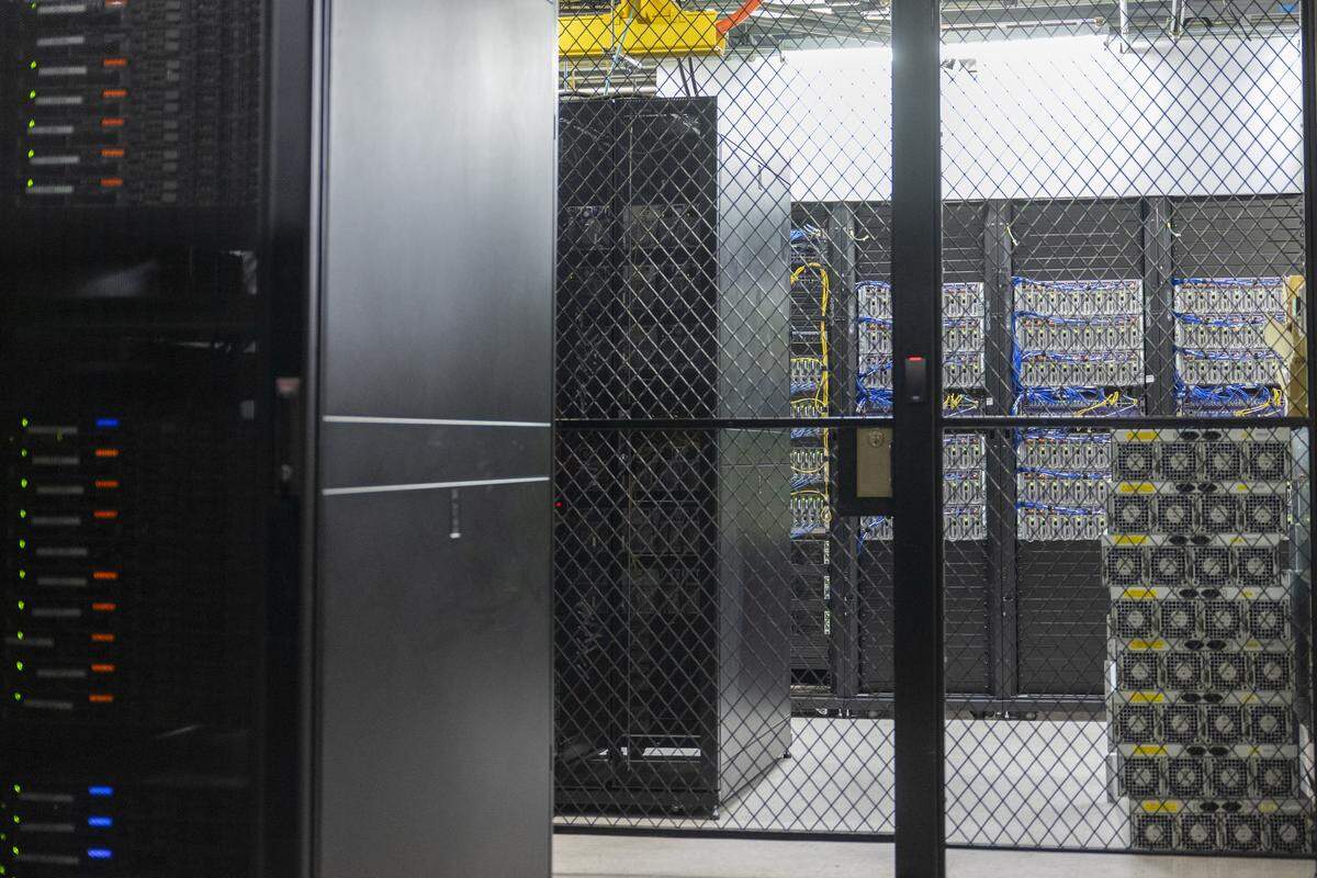 A collection of servers are kept in cages at the Colocation Northwest on Wednesday, Feb. 18, 2026, in downtown Tacoma, Wash.