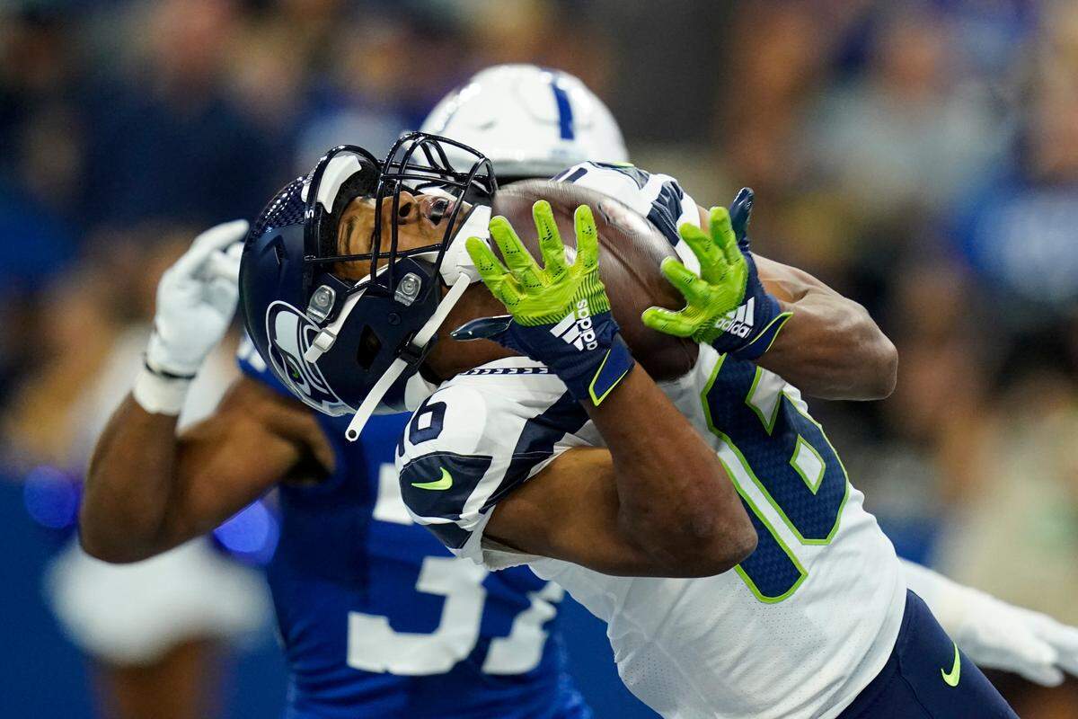 Seattle Seahawks wide receiver Tyler Lockett (16) makes catch for a touchdown in front of Indianapolis Colts safety Khari Willis (37) in the first half of an NFL football game in Indianapolis, Sunday, Sept. 12, 2021. (AP Photo/Charlie Neibergall)