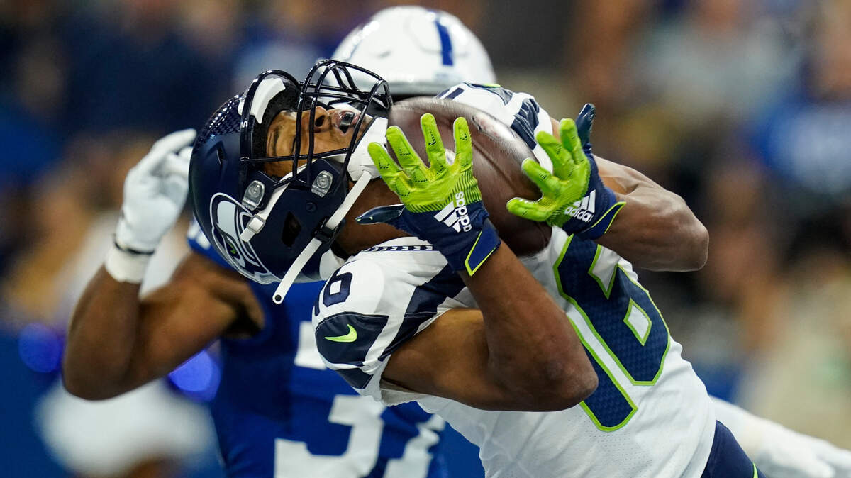Seattle Seahawks wide receiver Tyler Lockett (16) makes catch for a touchdown in front of Indianapolis Colts safety Khari Willis (37) in the first half of an NFL football game in Indianapolis, Sunday, Sept. 12, 2021. (AP Photo/Charlie Neibergall)