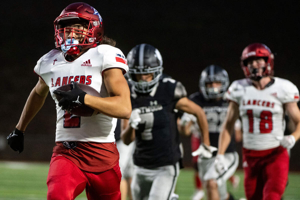Kennedy Catholic receiver Mason Moriarty races down the field past Kentwood defenders for a touchdown in the third quarter of a 4A NPSL game on Thursday, Sept. 15, 2022, at French Field in Kent, Wash. The long touchdown ended up being negated because of a block-in-the-back penalty.