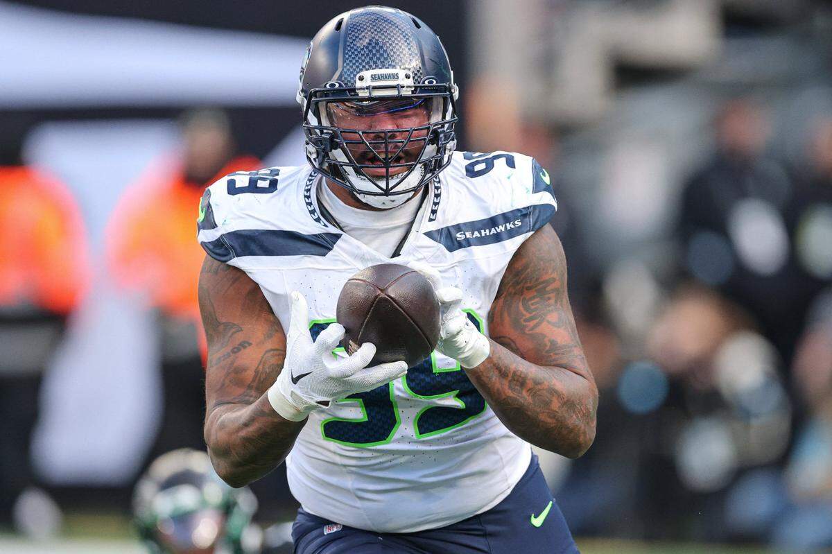 Seattle Seahawks defensive end Leonard Williams (99) intercepts a pass for a touchdown during the first half against the New York Jets at MetLife Stadium. Mandatory Credit: Vincent Carchietta-Imagn Images