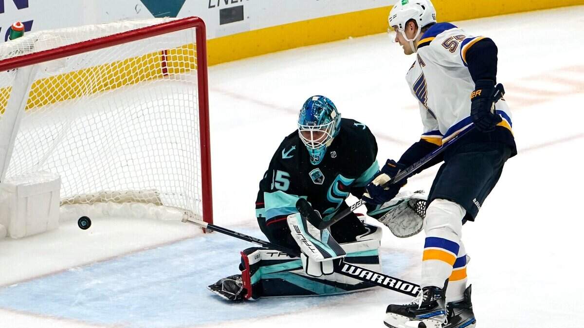St. Louis Blues’ Colton Parayko, right, scores against Seattle Kraken goaltender Joey Daccord on a penalty shot during the third period of an NHL hockey game Friday, Jan. 21, 2022, in Seattle. (AP Photo/Elaine Thompson)