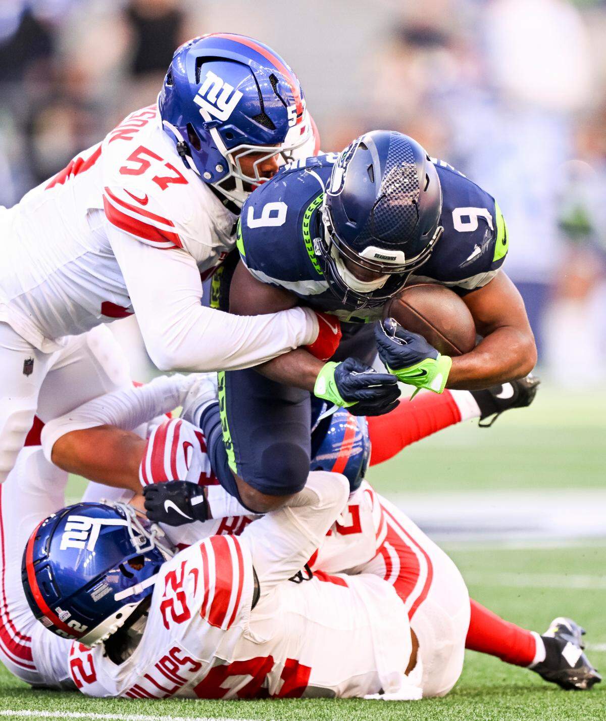 Seattle Seahawks running back Kenneth Walker III (9) is tackle by New York Giants linebacker Patrick Johnson (57) and cornerback Dru Phillips (22) during the fourth quarter of the game at Lumen Field, on Sunday, Oct. 6, 2024 in Seattle, Wash.