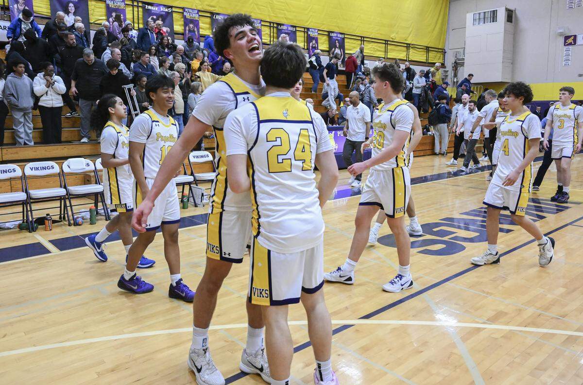 Puyallup senior Mason Sonntag (0) celebrates with Puyallup freshman Westin LaRance (24) after their win over Olympia on Thursday, Jan. 15, 2026, in Puyallup, Wash.