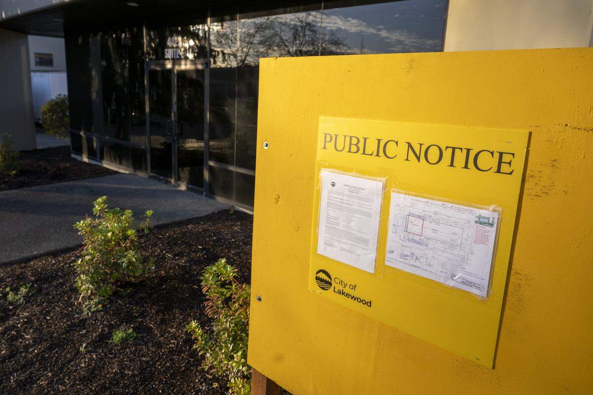 A public notice sign is posted outside of a building at Lakewood Industrial Park, pictured on Tuesday, Nov. 18, 2025, in Lakewood, Wash. A sports complex is proposed for the site.