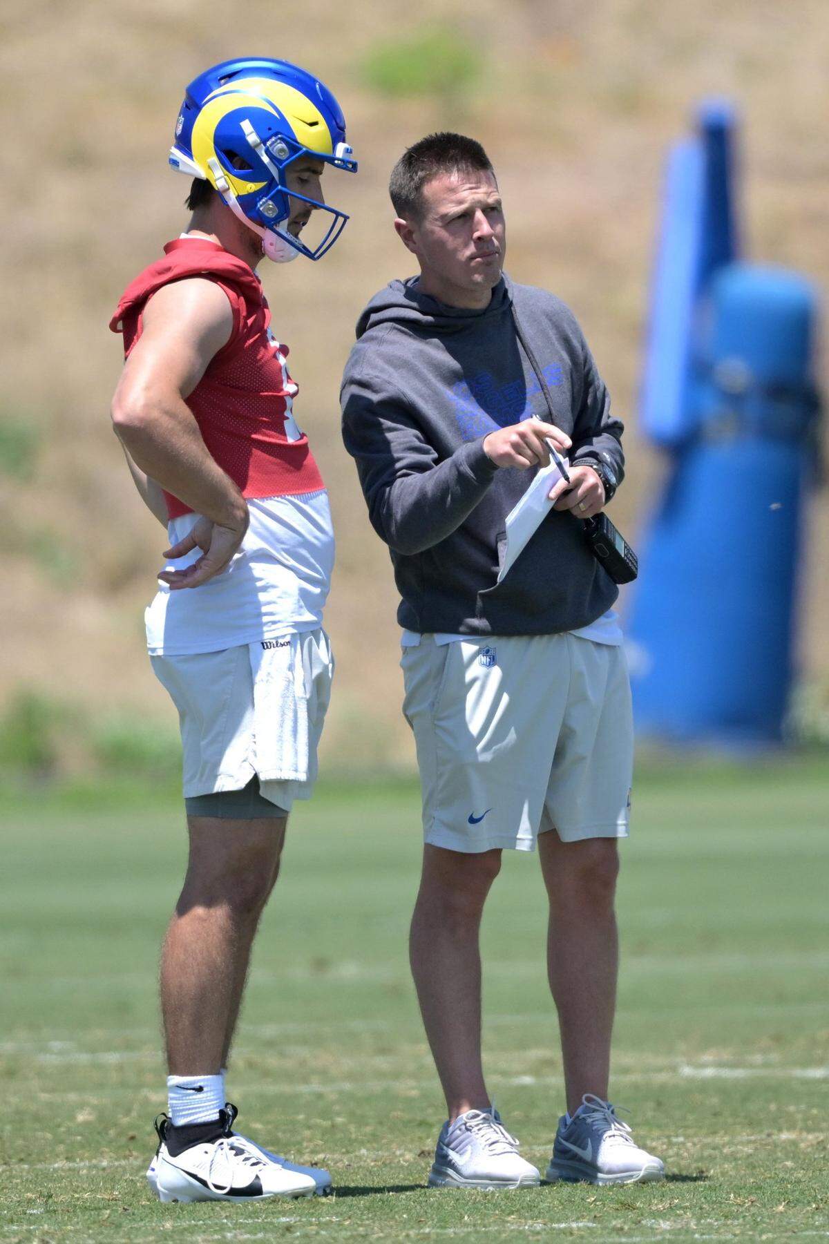 May 28, 2024; Thousand Oaks, CA, USA; Los Angeles Rams quarterback Stetson Bennett (13) talks with offensive coordinator Mike Lafleur during OTAs at the team training facility at California Lutheran University. Mandatory Credit: Jayne Kamin-Oncea-USA TODAY Sports