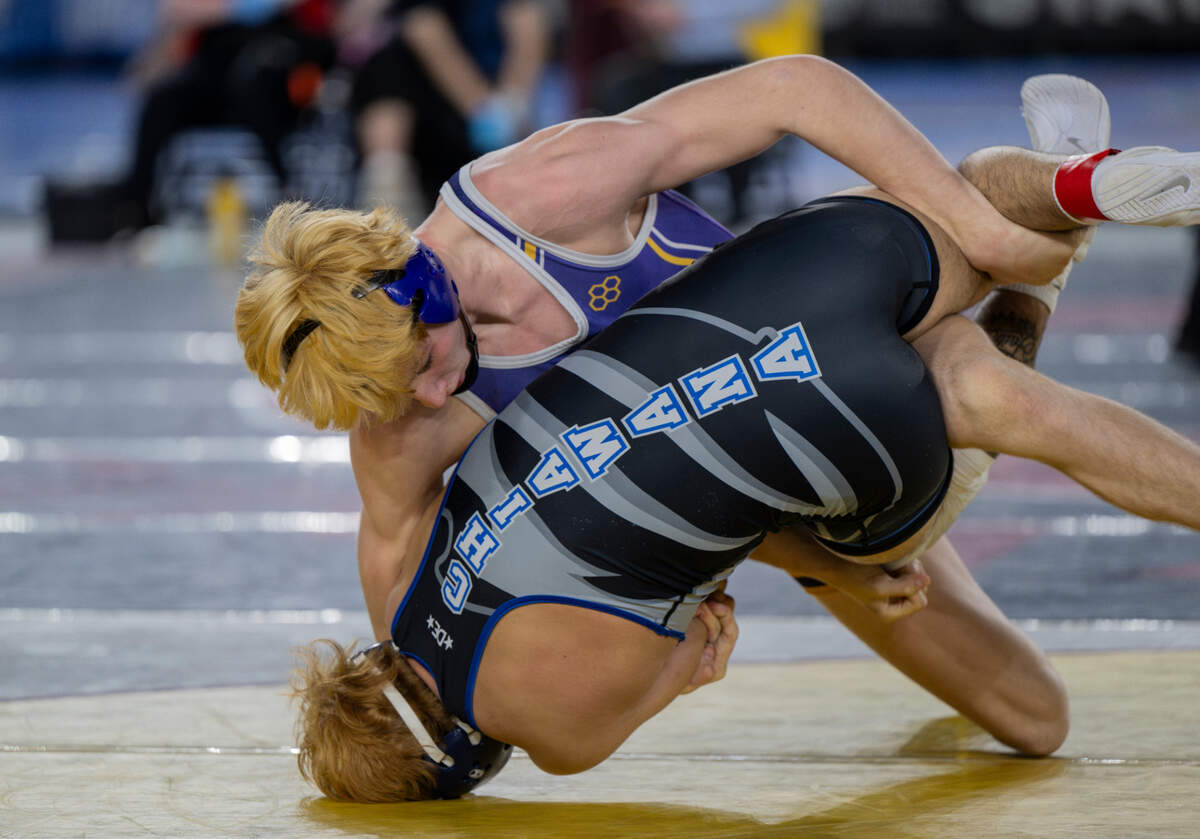 Sumner’s Cody Miller scopes up Chiawana’s Hunter Taylor in the 157-pound 4A semifinal match during day two of the Mat Classic XXXV at the Tacoma Dome on Saturday, Feb. 17, 2024, in Tacoma, Washington.