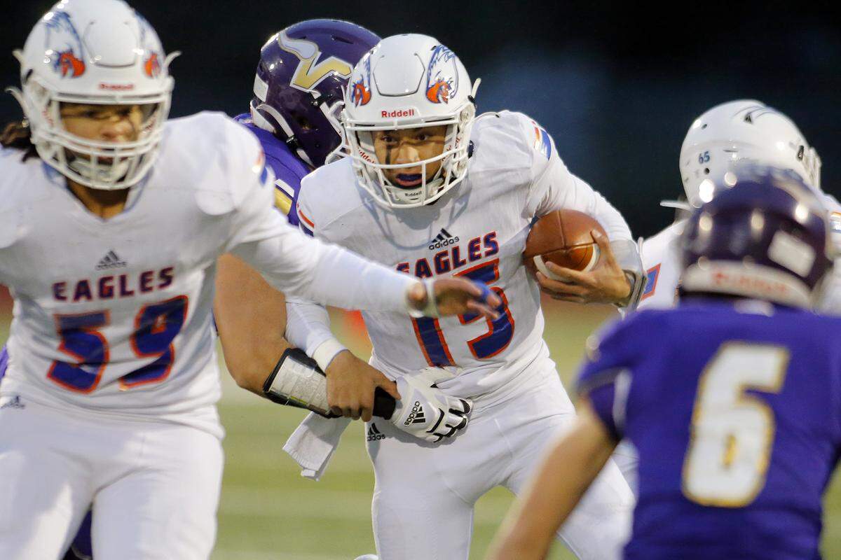 Graham-Kapowsin’s Daveon Superales keeps the ball on a quarterback run during the 4A semifinal against Lake Stevens on Saturday, Nov. 26, 2022, at Lake Stevens High School in Lake Stevens, Washington. (Ryan Berry / The Herald)