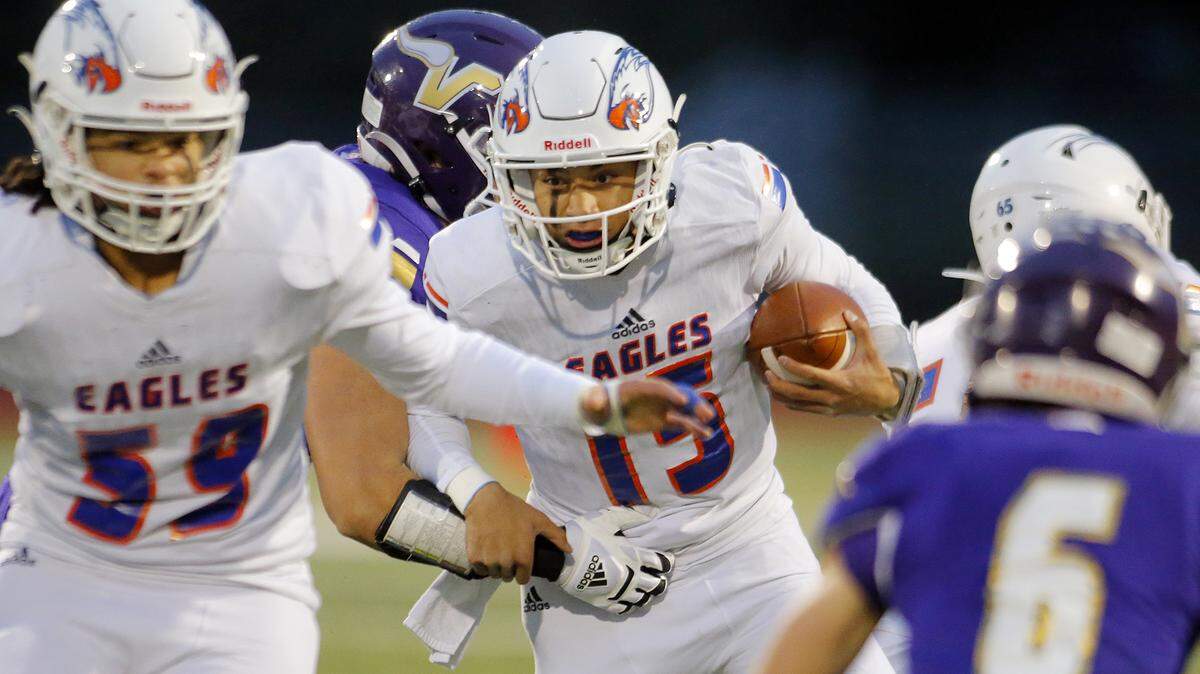 Graham-Kapowsin’s Daveon Superales keeps the ball on a quarterback run during the 4A semifinal against Lake Stevens on Saturday, Nov. 26, 2022, at Lake Stevens High School in Lake Stevens, Washington. (Ryan Berry / The Herald)