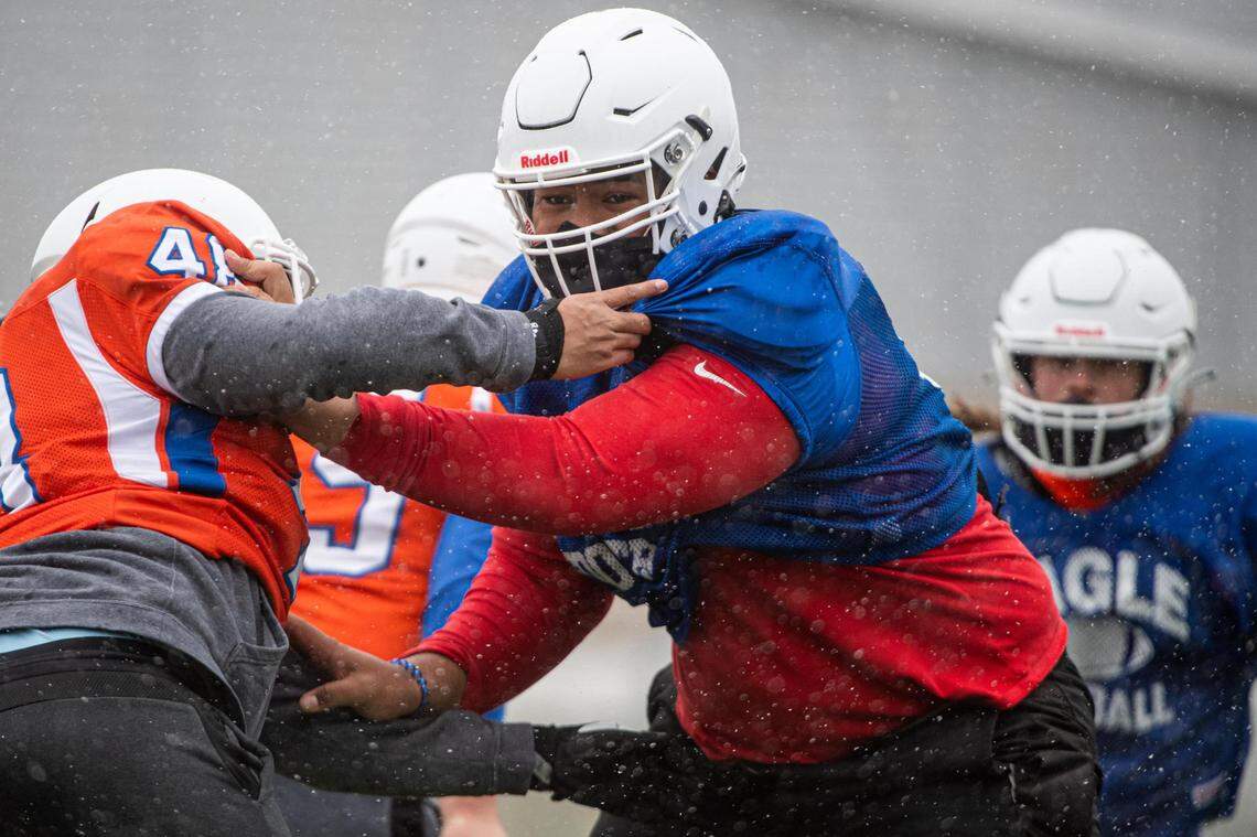 Vega Ioane sheds a blocker during drills at Graham-Kapowsin high school football practice in Graham, Wash., on Thursday, Feb. 11, 2021.