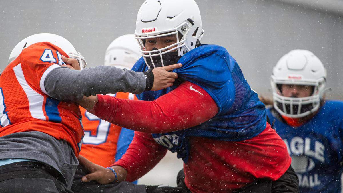 Vega Ioane sheds a blocker during drills at Graham-Kapowsin high school football practice in Graham, Wash., on Thursday, Feb. 11, 2021.