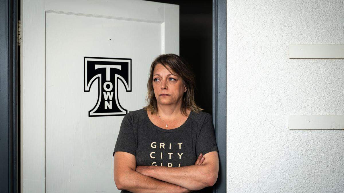 Gail Ringrose poses for a portrait inside the T Town Apparel location on Market Street in downtown Tacoma, Washington, on Tuesday, Aug. 30, 2022. Ringrose’s husband, Pat, died on Aug. 13, 2022. She is closing the Market Street location and moving all of the company’s equipment to their location in Proctor.