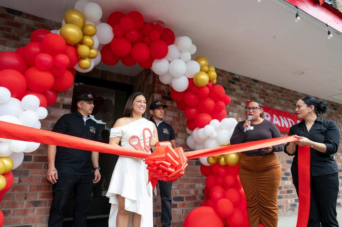 Co-creators of Welcome Restaurant, from left: German Espitia, Paty Pinedo and Juan Agudelo celebrate their grand opening on Thursday, July 10, 2025, in Ruston. Pinedo’s sister, Diana, holds the ribbon on the right.
