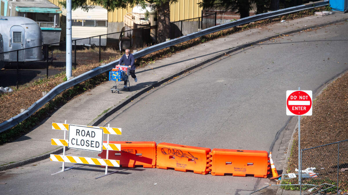 A man walks down the Union Avenue off-ramp while it is under construction on Friday, Sept. 29, 2023, in Tacoma. After a fire damaged the off-ramp on Feb. 27, 2023, the reconstruction project is now 50 percent complete.