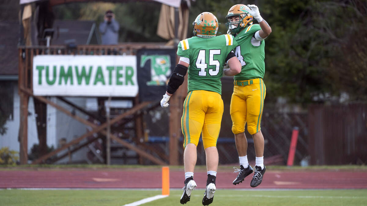Tumwater tight end Jake Dillon (45) celebrates wide receiver Sunny Nguyen’s touchdown run during Saturday afternoon’s state playoff game against the Sehome Mariners at Tumwater District Stadium in Tumwater, Washington, on Friday, Nov. 23, 2024. Tumwater won the game, 70-7, to advance to the state semifinals.