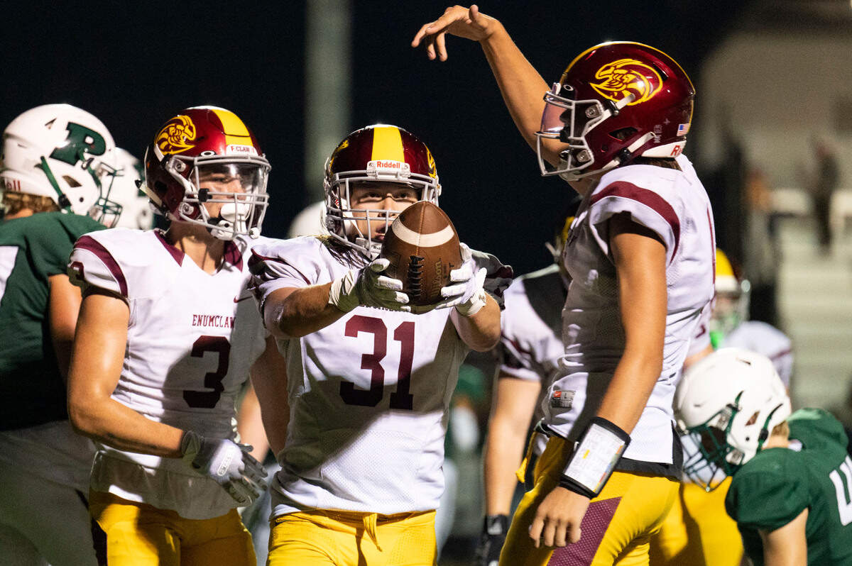 After rushing in for a touchdown, Enumclaw running back Emmit Otero looks to toss the ball to the referee during the fourth quarter of a nonleague game on Thursday, Sept. 1, 2022, at Roy Anderson Field in Gig Harbor Wash.