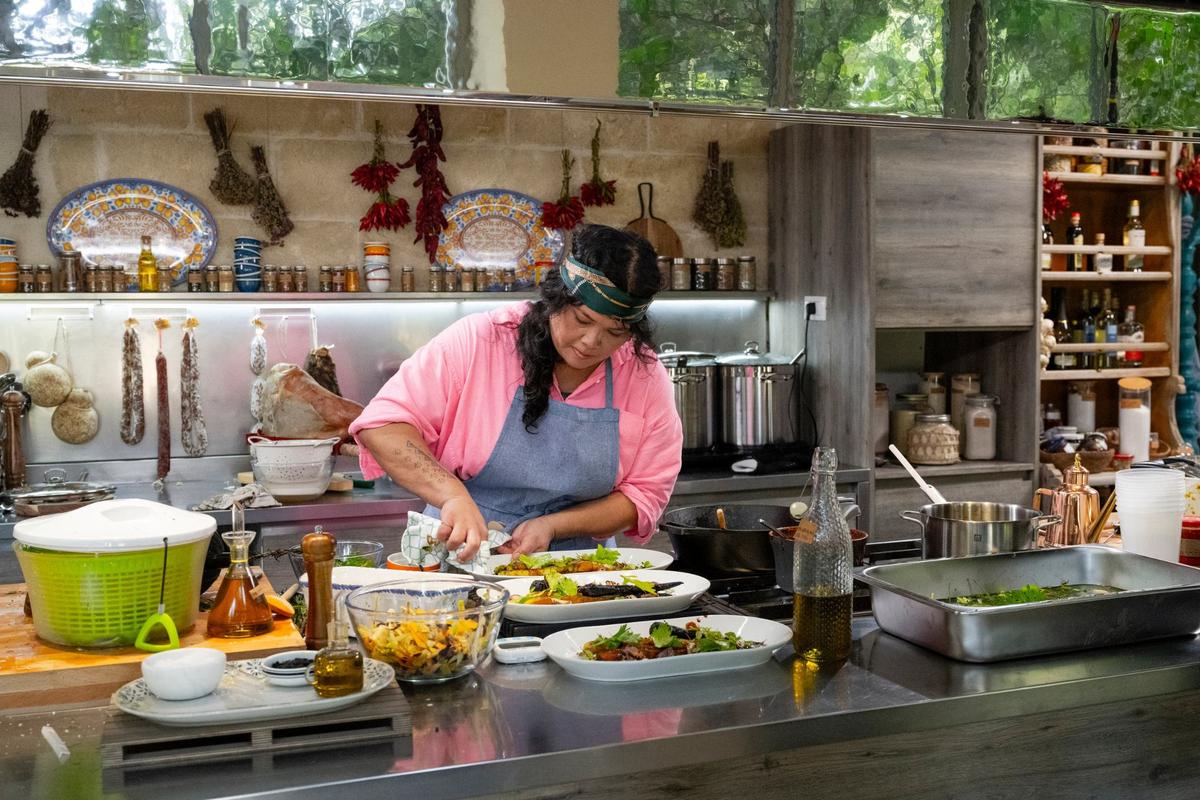 Contestant Jan Parker, polishing details of the adobo agrodolce roasted carrots as seen on Season 2 of Food Network’s “Ciao House” with hosts Alex Guarnaschelli and Gabe Bertaccini.