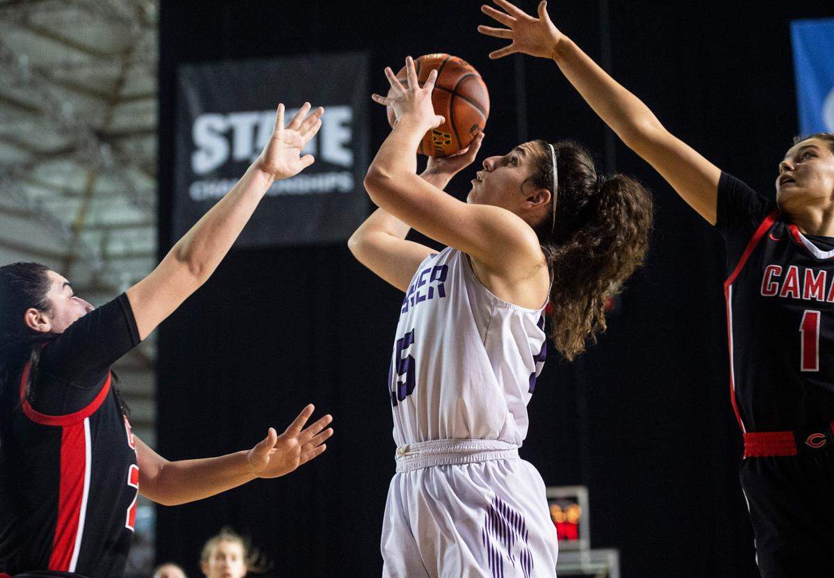 Sumner’s forward Catelyn Deaver (15) drives to the basket as Camas’s guard Ava Smith (24) and Camas’s guard Reagan Jamison (1) defend during the Class 4A quarterfinal state tournament game on Thursday, March 3, 2022, at the Tacoma Dome, in Tacoma, Wash.