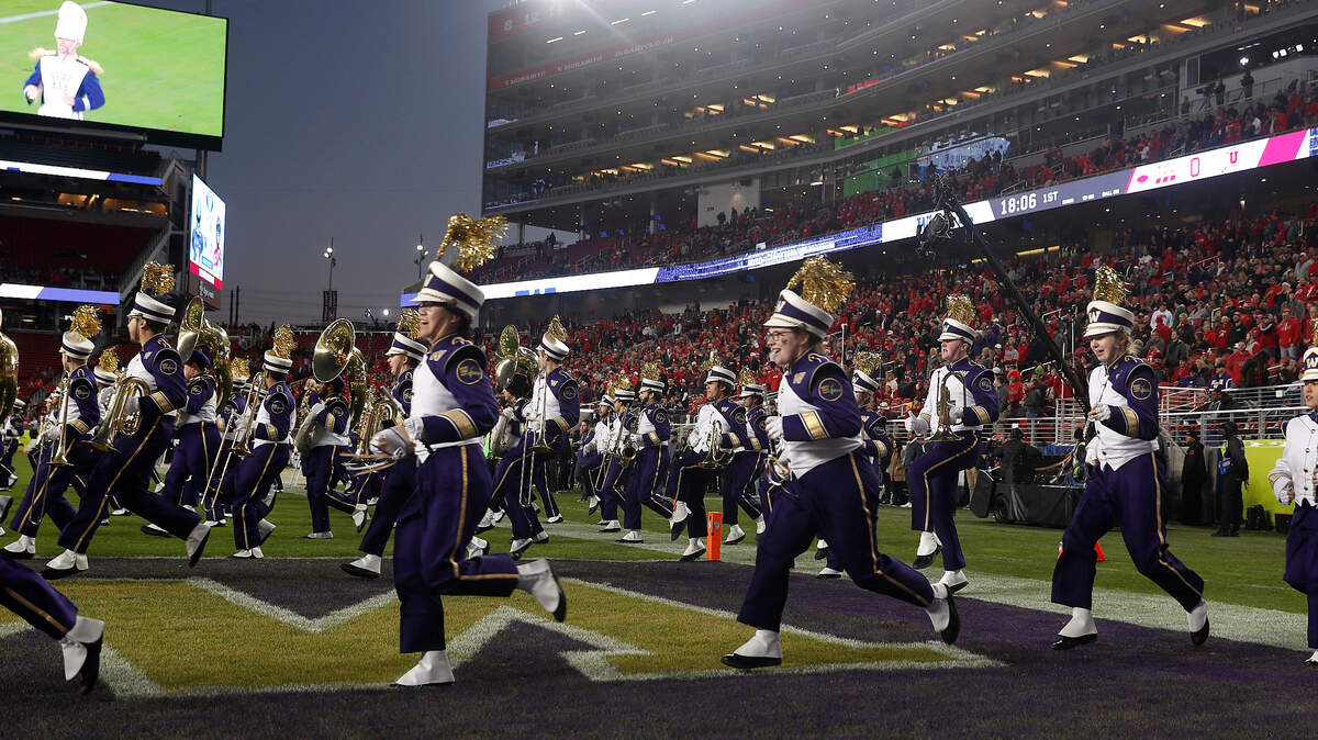 Members of the Washington band run onto the field after Washington beat Utah in the Pac-12 Conference championship NCAA college football game in Santa Clara, Calif., Friday, Nov. 30, 2018. (AP Photo/Tony Avelar)