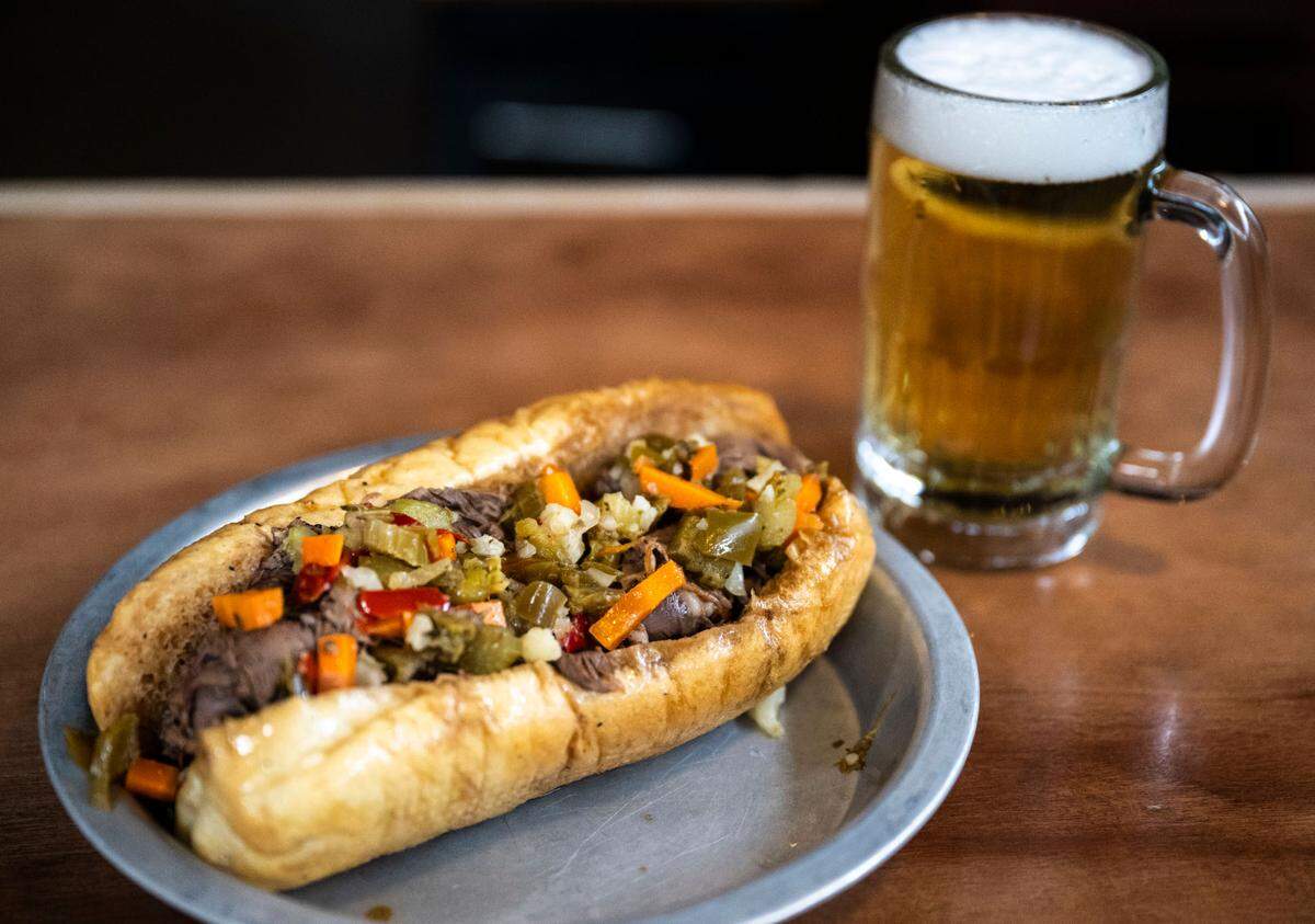 A freshly made Italian beef sandwich topped with giardiniera, an Italian condiment made of pickled vegetables that has become popular in Chicago, is a new Tuesday-only special at The Red Hot in Tacoma, Wash.