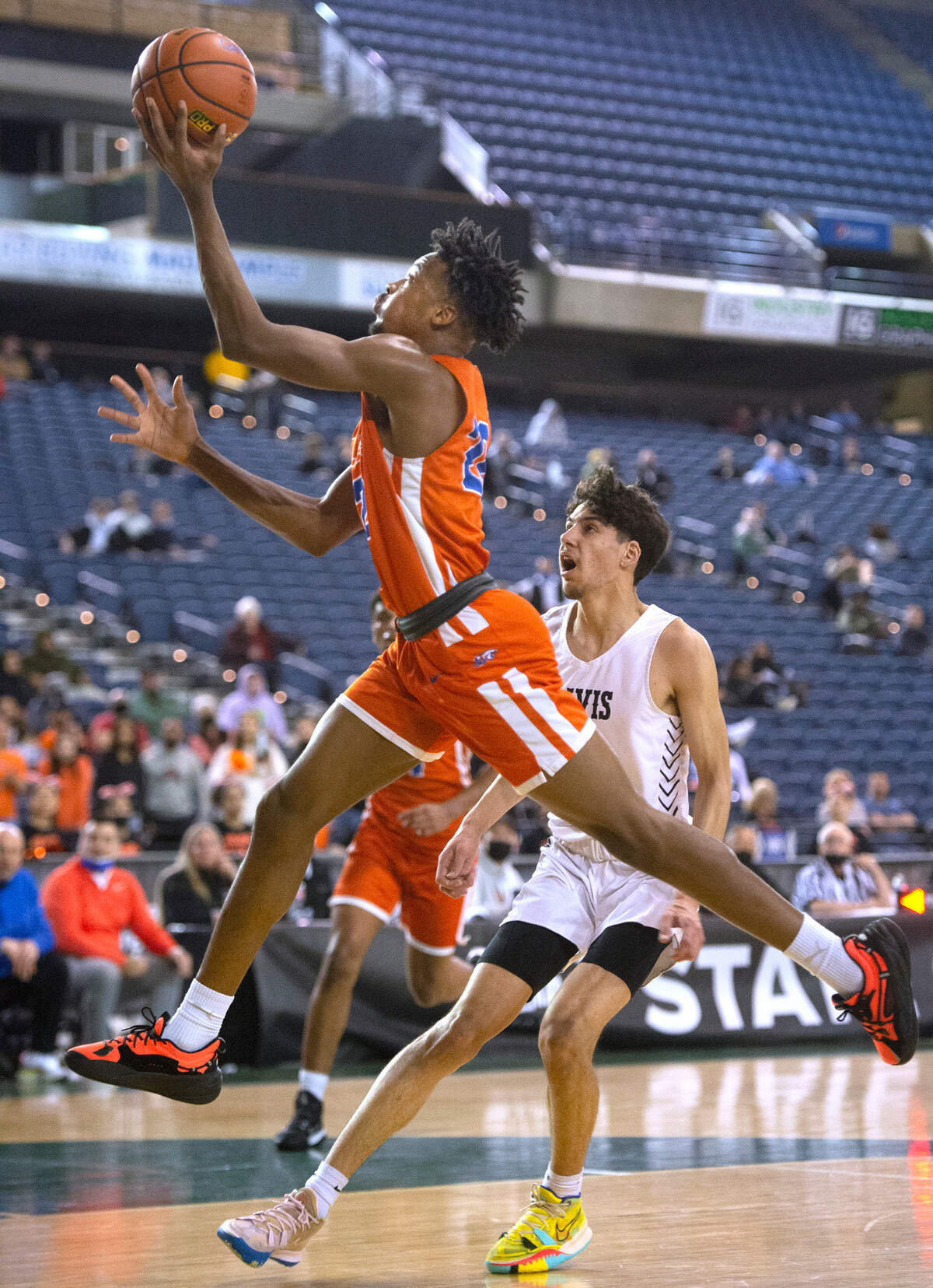 Graham-Kapowsin’s Christian Ballah flies to the hoop in front of Davis defender Blake Garza during Wednesday afternoon’s opening-round game of the WIAA 4A Boys Basketball State Championships tournament in the Tacoma Dome in Tacoma, Washington, on Wednesday, March 2, 2022.