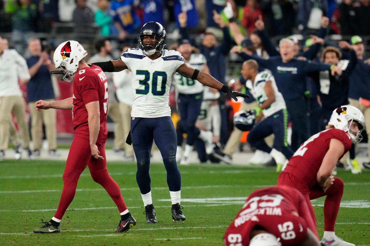 Seattle Seahawks cornerback Michael Jackson (30) celebrates as Arizona Cardinals place kicker Matt Prater (5) walks off the field after missing a 51-yard field goal attempt as time runs out in the fourth quarter of an NFL football game Sunday, Jan. 7, 2024, in Glendale, Ariz. The Seahawks won 21-20. (AP Photo/Ross D. Franklin)