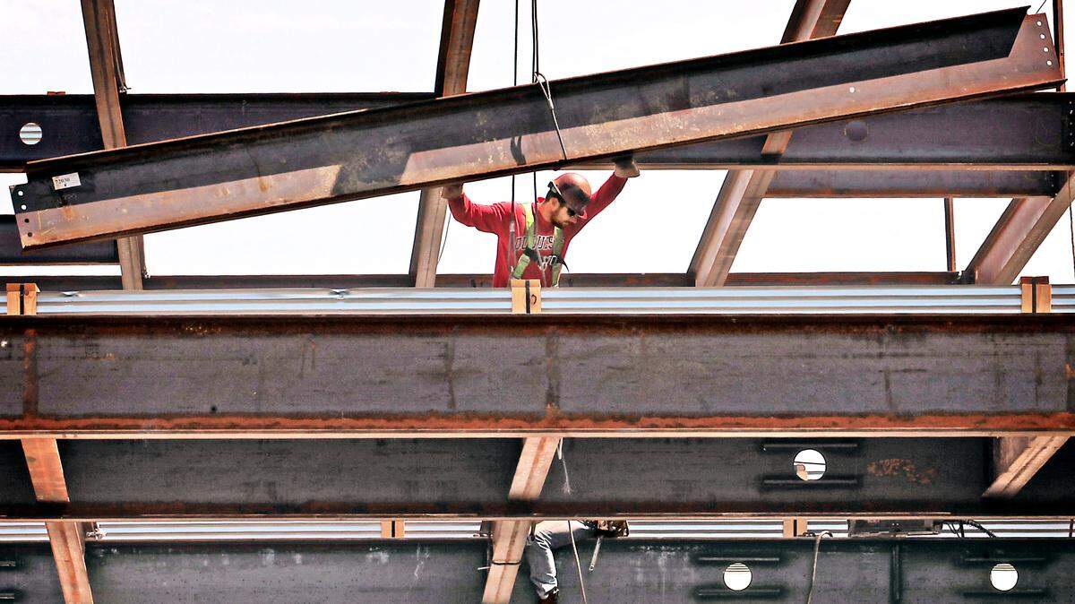An iron worker checks his footing while helping to guide a steel beam in Tacoma in 2012. An iron worker pre-apprenticeship program is taking applicants for its next round of training.