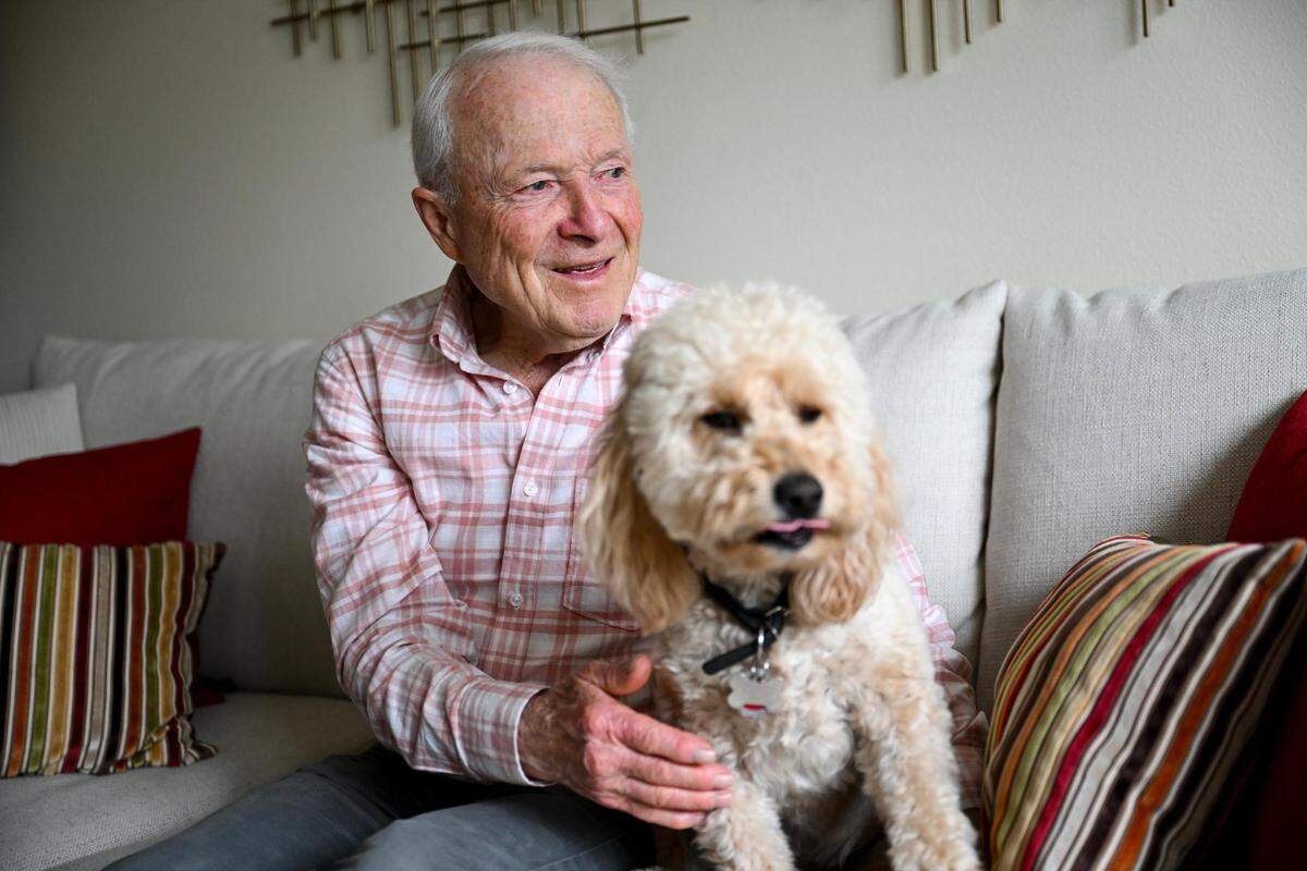Dave Pine, 88, and Scooter at home, Wednesday, Aug. 9, 2023, in Gig Harbor, Wash. Pine recently finished a seven-day trek through the Cascades and walks Scooter every day to try to stay active.