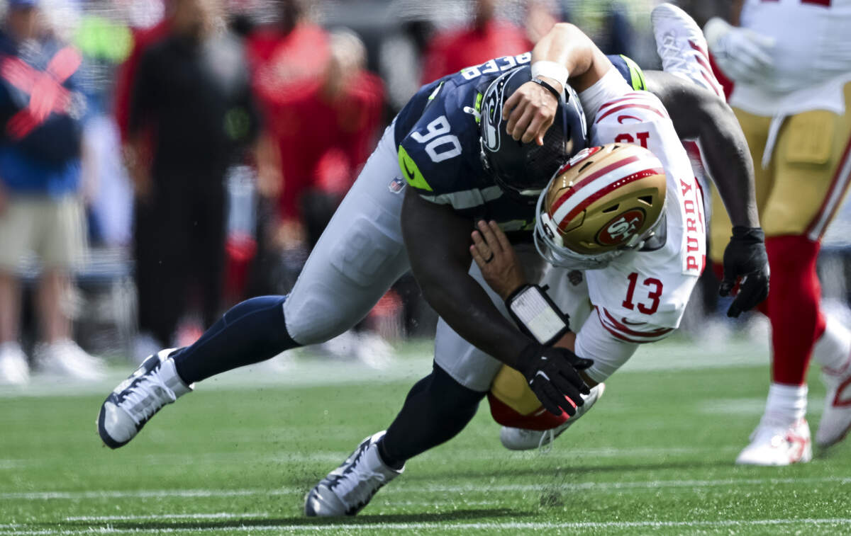 Seattle Seahawks defensive tackle Jarran Reed (90) hits San Francisco 49ers quarterback Brock Purdy (13) during the second quarter of the game at Lumen Field, on Sunday, Sept. 7, 2025, in Seattle.