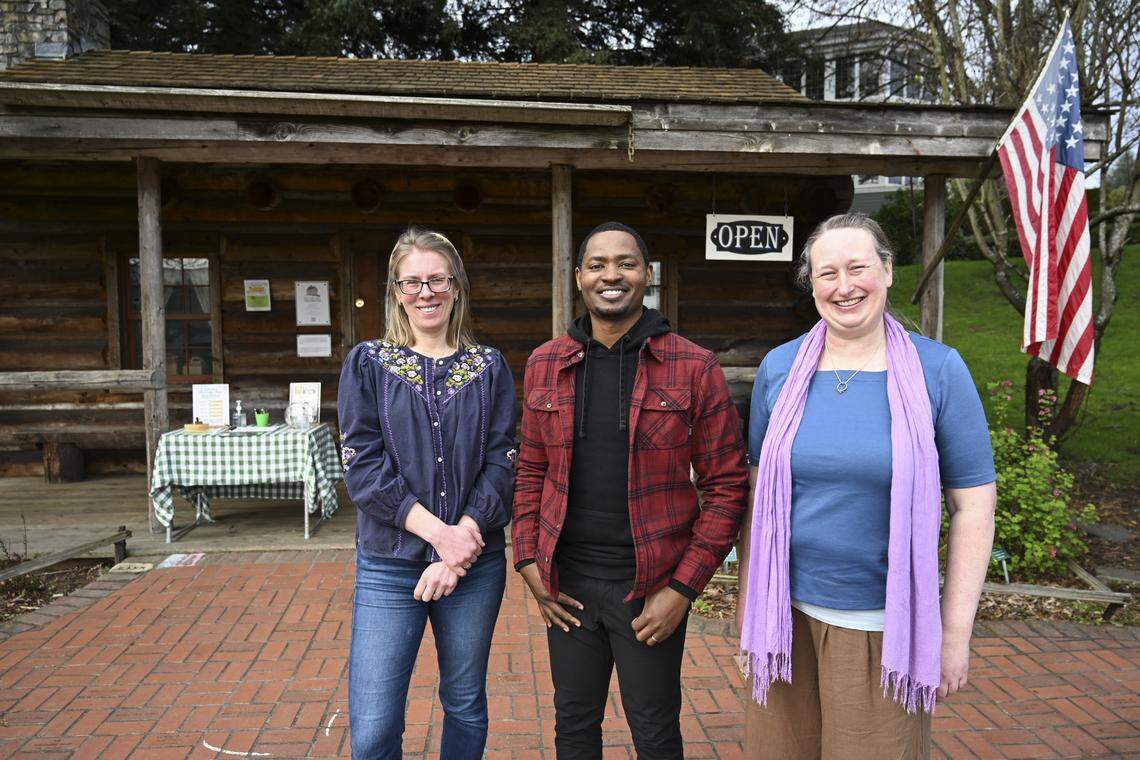 The Job Carr Museum’s outgoing executive director Courtney Bird, left, new executive director Marquise Dixon, center, and program manager Holly Stewart stand outside of the museum on Friday, April 3, 2026, at Old Town Park in Tacoma, Wash.