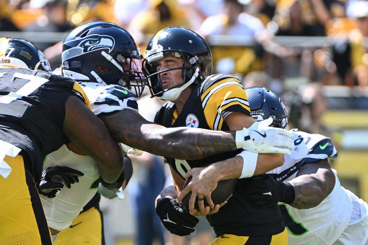 Sep 14, 2025; Pittsburgh, Pennsylvania, USA; Seattle Seahawks defensive end Leonard Williams (99) and defensive tackle Byron Murphy II (91) sack Pittsburgh Steelers quarterback Aaron Rodgers (8) during the second quarter at Acrisure Stadium. Mandatory Credit: Barry Reeger-Imagn Images