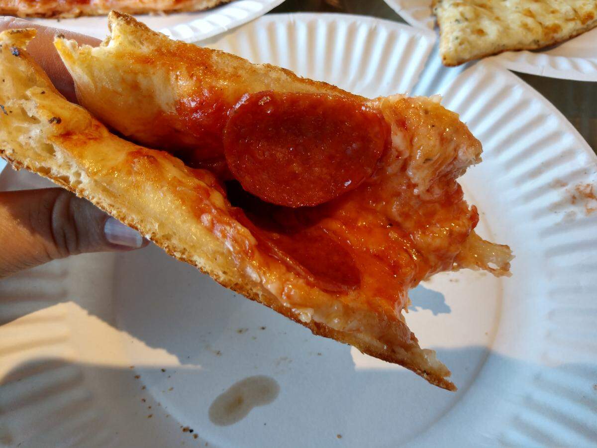 The best way to eat New York-style pizza is to fold it and jam it into your mouth.