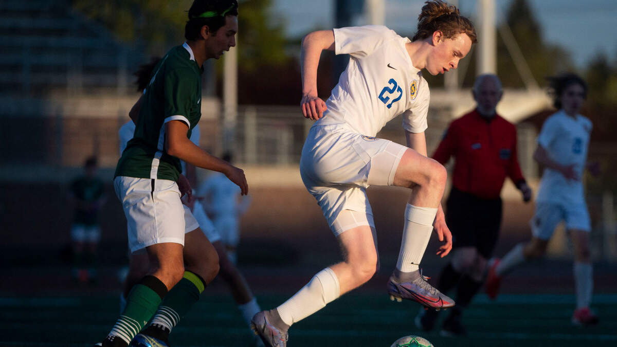 Stadium forward Owen Bliskis dribbles into space as Peninsula’s Dylan Ladds defends during the first half of a 3A District 3/4 semifinal game on Tuesday, May 10, 2022, at Mount Tahoma High School in Tacoma, Wash.