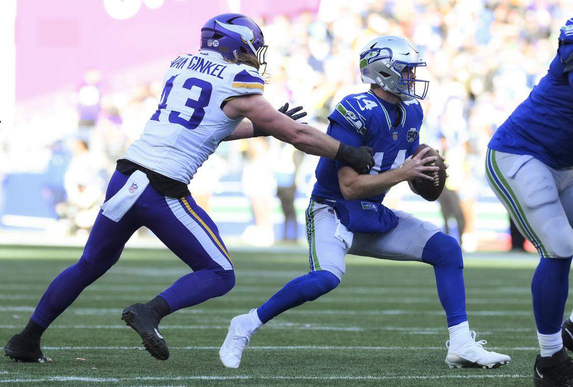 Seattle Seahawks quarterback Sam Darnold (14) is sacked by Minnesota Vikings linebacker Andrew Van Ginkel (43) during the second quarter of the game at Lumen Field, on Sunday, Nov. 30, 2025, in Seattle.