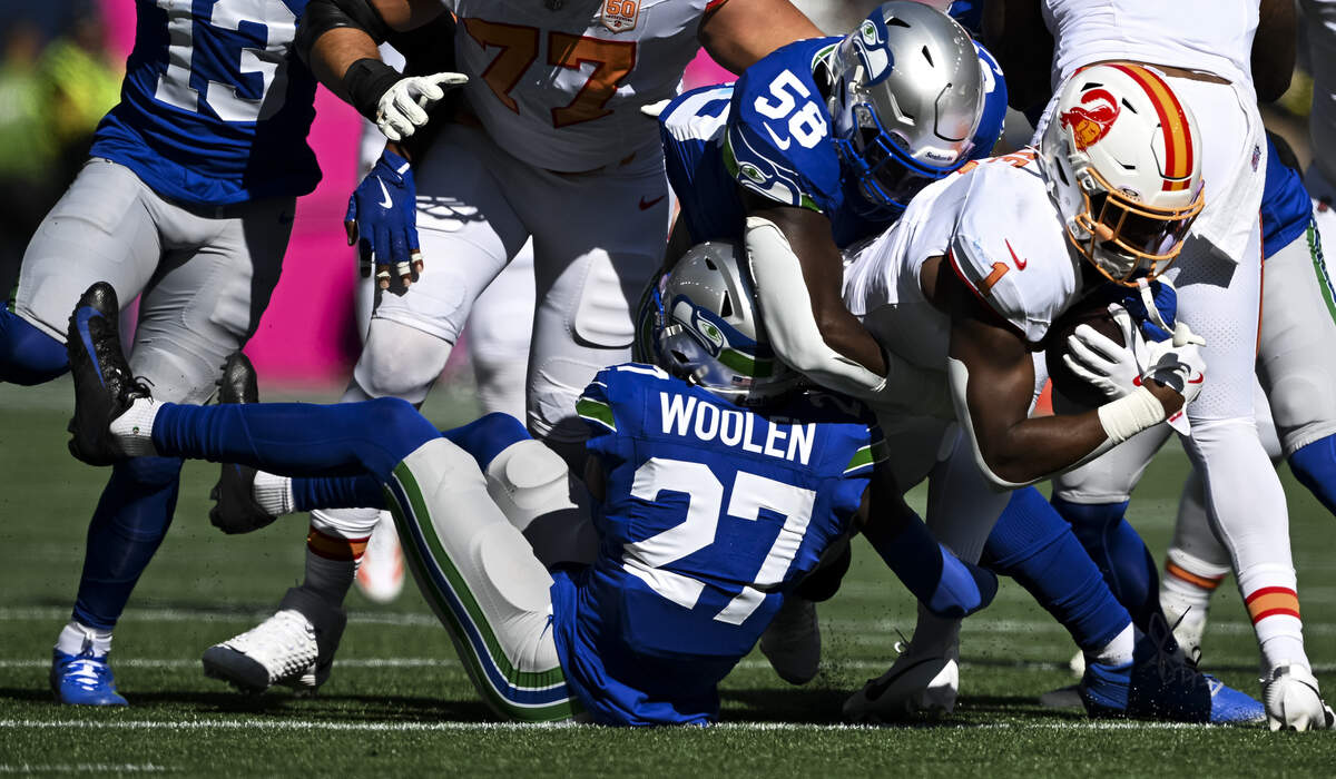 Tampa Bay Buccaneers running back Rachaad White (1) is tackled by Seattle Seahawks cornerback Riq Woolen (27) and linebacker Derick Hall (58) of the game at Lumen Field, on Sunday, Oct. 5, 2025, in Seattle.