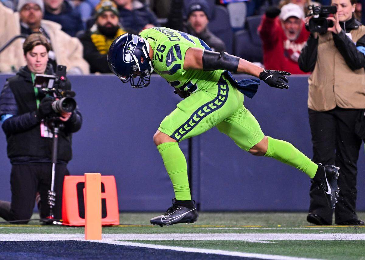 Seattle Seahawks running back Zach Charbonnet (26) runs in a 25-yard touchdown during the fourth quarter of the game against the Green Bay Packers at Lumen Field, on Sunday, Dec. 15, 2024, in Seattle, Wash.