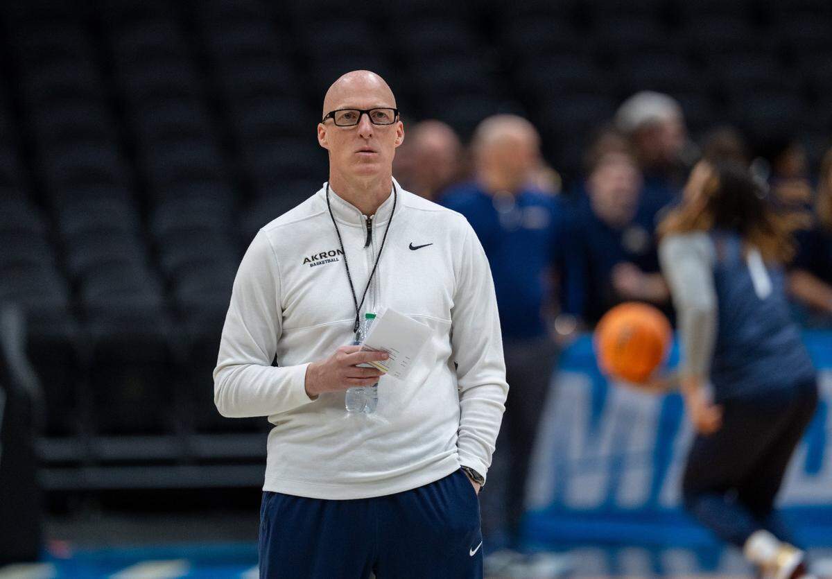 Mar 20, 2025; Seattle, WA, USA; Akron Zips head coach John Groce watches practice at Climate Pledge Arena. Mandatory Credit: Stephen Brashear-Imagn Images