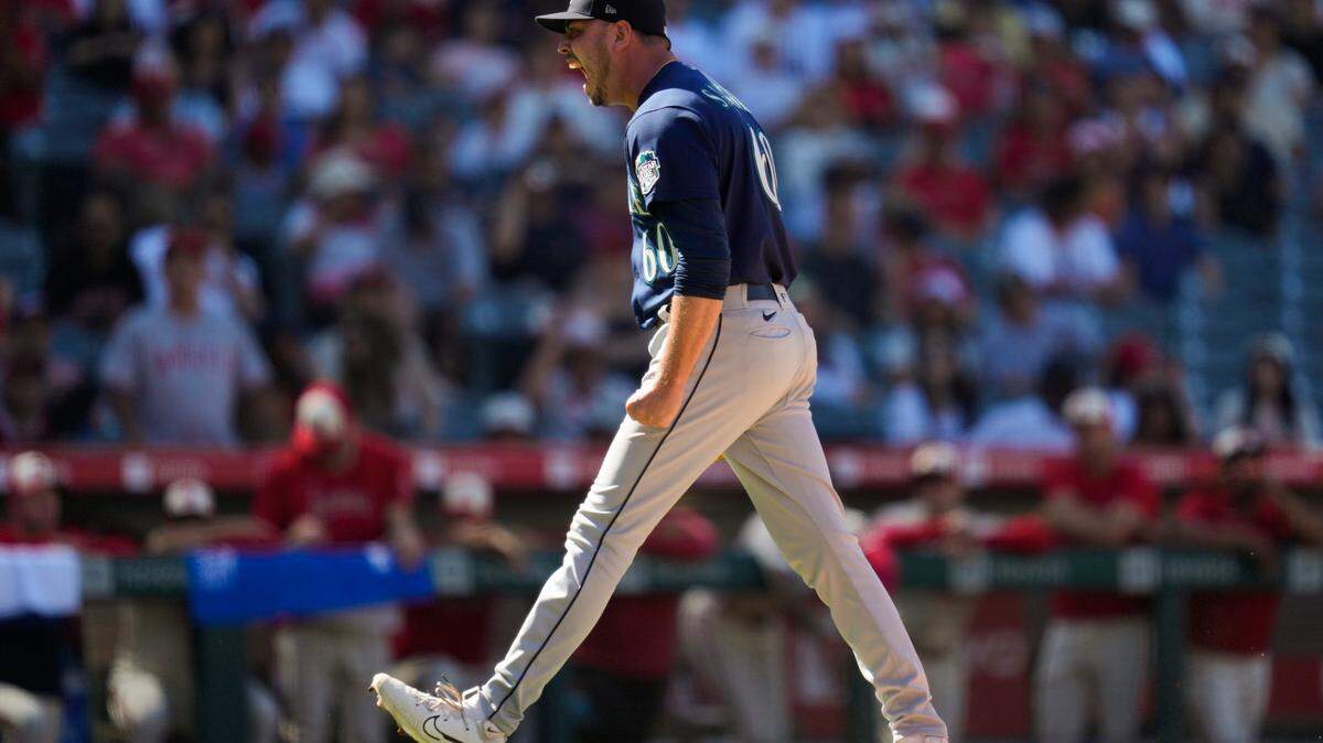 Seattle Mariners relief pitcher Tayler Saucedo (60) celebrates after a 3-2 win over the Los Angeles Angels in a baseball game in Anaheim, Calif., Sunday, Aug. 6, 2023. (AP Photo/Ashley Landis)