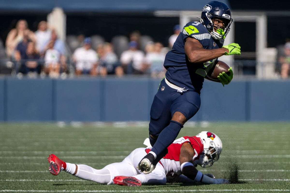 Seattle Seahawks running back Kenneth Walker III (9) breaks away from a tackle attempt by Arizona Cardinals safety Budda Baker (3) during the first quarter of an NFL game on Sunday, Oct. 16, 2022, at Lumen Field in Seattle.