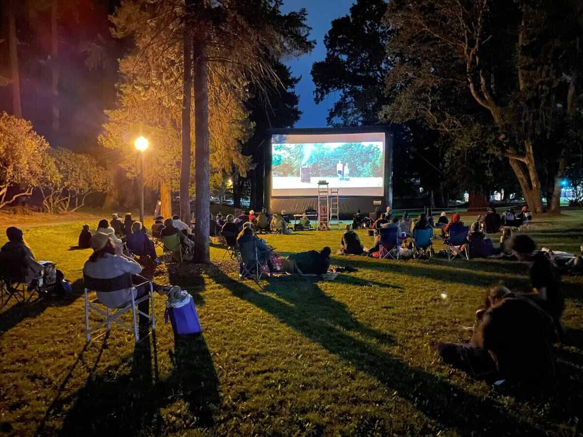 Tacoma residents recline in lawn chairs and lay on blankets while the movie “Minari” plays at the Asia Pacific Cultural Center.
