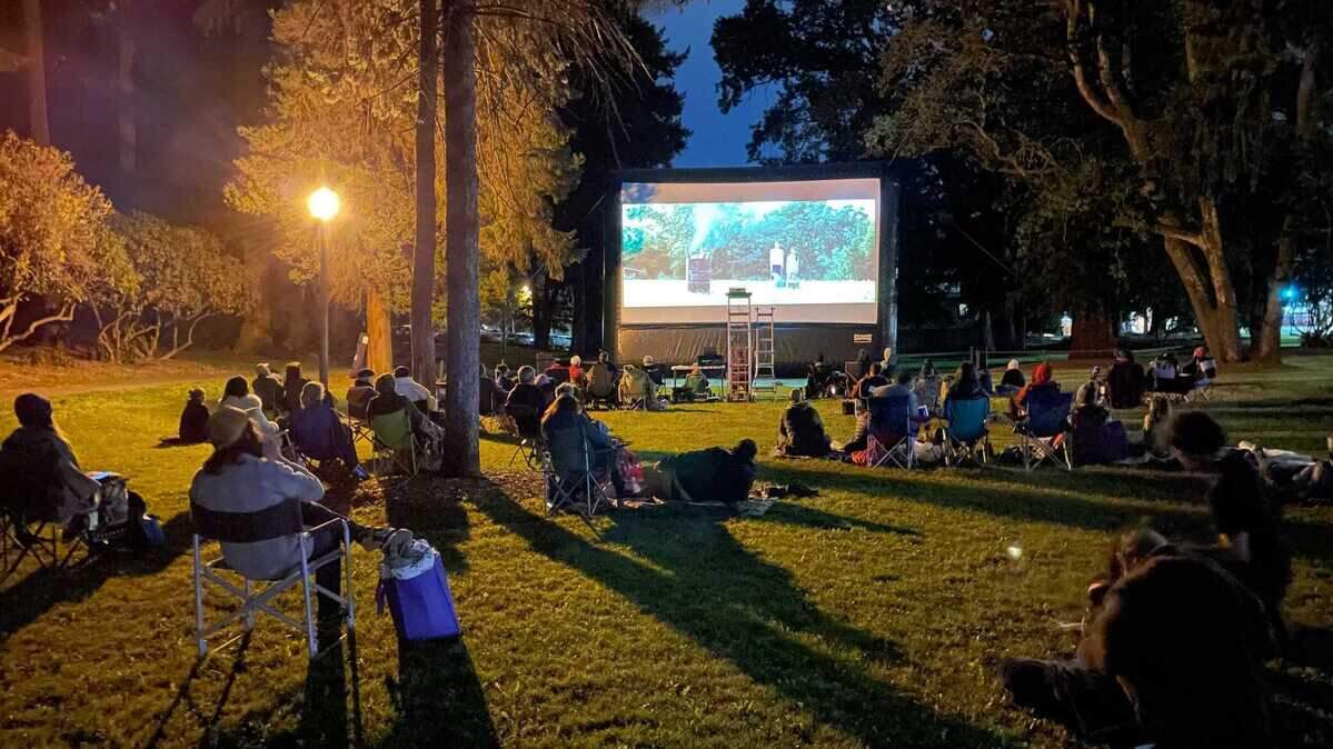Tacoma residents recline in lawn chairs and lay on blankets while the movie “Minari” plays at the Asia Pacific Cultural Center last summer.