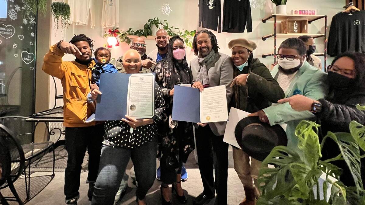 JMarie Johnson-Kola, left, holding Pierce County Council’s proclamation honoring February as Black History Month and pastor Ronelle McGraw Jr. from Praise Chapel Church Of God In Christ, right, holding Puyallup City Council’s proclamation.