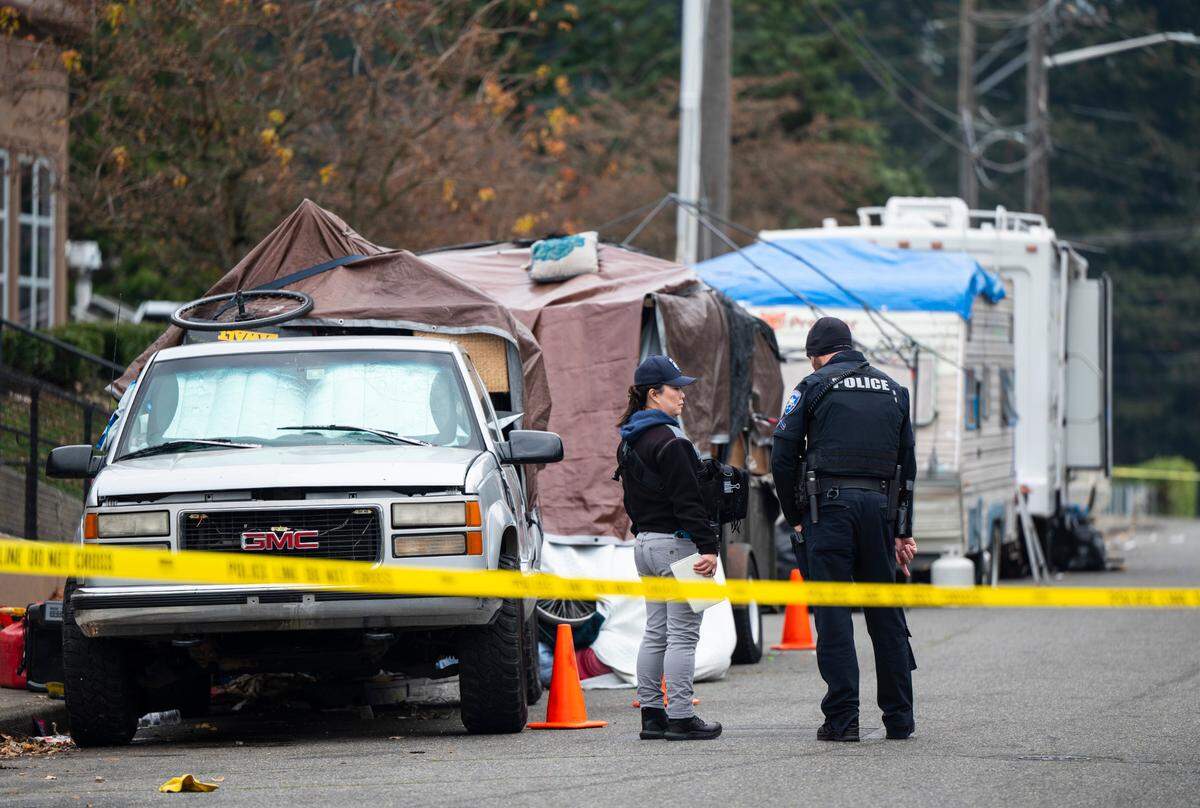Crime scene technicians and Tacoma Police Department officers investigate a crime scene where two men were found dead with gunshot wounds near the 8000 block of South Hosmer Street in Tacoma, Wash. on Nov. 21, 2022.