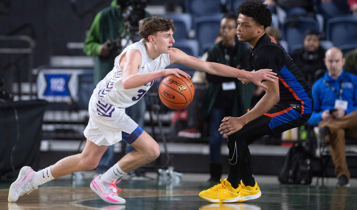 North Thurston’s Liam Sheeran drives against Rainier Beach defender Conner Seward during Wednesday morning’s opening-round game of the 3A boys state basketball tournament in the TacomaDome in Tacoma, Washington, on Wednesday, Feb. 28, 2024. Rainier Beach won the game, 66-45.