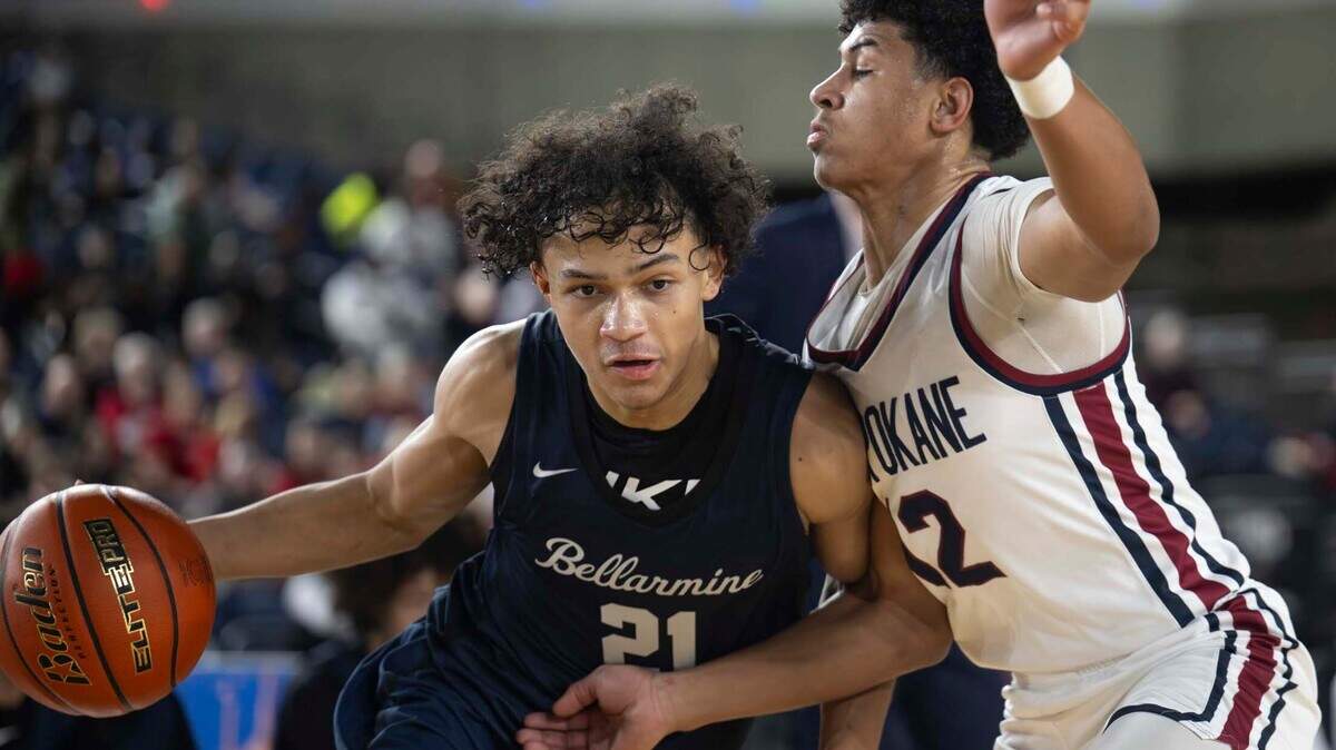 Bellarmine Prep guard Ronnie Wiggins (21) dribbles to the basket as Mt. Spokane guard Rock Franklin (12) defends during the second half of a Class 3A state basketball tournament quarterfinal game at the Tacoma Dome on Thursday, March 6, 2025, in Tacoma, Wash.
