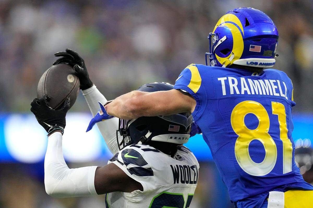 Seattle Seahawks cornerback Riq Woolen (27) intercepts a catch intended for Los Angeles Rams wide receiver Austin Trammell (81) during the second half of an NFL football game Sunday, Nov. 19, 2023, in Inglewood, Calif. (AP Photo/Mark J. Terrill)