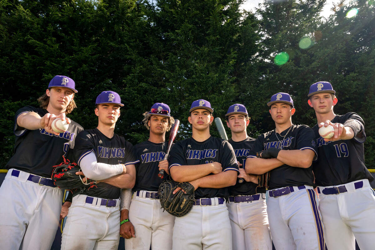 Puyallup players (from left) Adam Brooks, Tristan Ringrose, Donte Grant, Kai Halstead, Jeremiah Crain, Noah Fields, Brett Ellingson pose for a portrait on their home field in Puyallup, Wash., on Thursday, April 7, 2022.