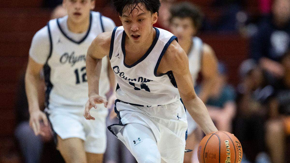 After stealing the ball away from a North Creek player, Olympia guard Julian Zapata (13) dribbles up court during the fourth quarter of a Class 4A regional round of the state tournament game on Saturday, March 1, 2025, at the University of Puget Sound in Tacoma, Wash.