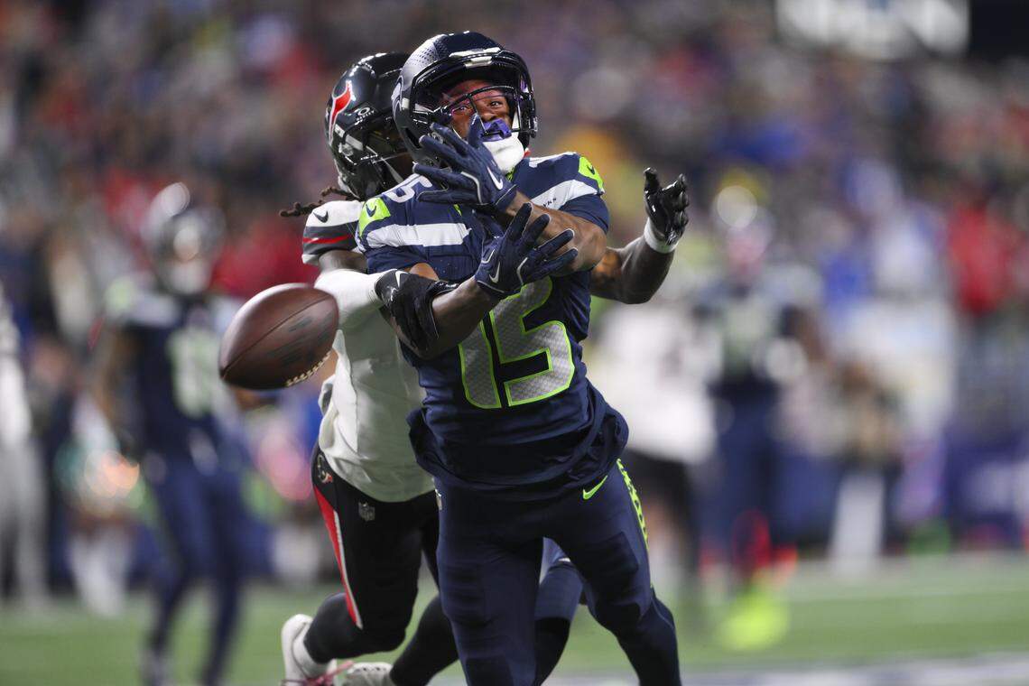 Seattle Seahawks wide receiver Tory Horton (15) nearly makes a contested catch against Houston Texans safety Jalen Pitre (5) during the first quarter of the game at Lumen Field, on Monday, Oct. 20, 2025, in Seattle.